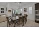 Dining room with large wood table, seating for eight, and natural light at 10181 Mount Harlow Ct, Las Vegas, NV 89141