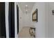Bright hallway featuring tile floors, contemporary decor, and access to various rooms at 10181 Mount Harlow Ct, Las Vegas, NV 89141