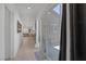 Bright hallway with a view of the open living space and outdoor patio through sliding glass doors at 10181 Mount Harlow Ct, Las Vegas, NV 89141