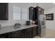Modern kitchen featuring dark cabinetry, stainless steel appliances, and a bright, well-lit countertop at 10181 Mount Harlow Ct, Las Vegas, NV 89141