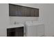 Practical laundry room includes cabinets, countertops, a sink, washer, and dryer at 10181 Mount Harlow Ct, Las Vegas, NV 89141