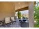 Relax on the cozy covered patio with comfortable seating and lush greenery at 10181 Mount Harlow Ct, Las Vegas, NV 89141