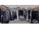 Spacious walk-in closet with plenty of storage space and a variety of hanging clothes, luggage, and containers at 10181 Mount Harlow Ct, Las Vegas, NV 89141
