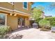 Spacious backyard with a concrete patio, mature trees, and privacy landscaping at 10404 Mystic Pine Rd, Las Vegas, NV 89135