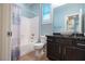 Updated bathroom features a dark vanity, vessel sink, and a tub with a shower at 10404 Mystic Pine Rd, Las Vegas, NV 89135