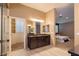 Main bathroom area with dual vanity, shower to the left, and bedroom area on the right at 10404 Mystic Pine Rd, Las Vegas, NV 89135