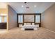 Spacious main bedroom with plush carpeting, shuttered windows, and ensuite bathroom at 10404 Mystic Pine Rd, Las Vegas, NV 89135