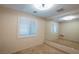 Cozy bedroom with plush carpeting, neutral walls, and bright, shuttered windows at 10404 Mystic Pine Rd, Las Vegas, NV 89135