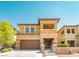 Inviting two-story home with a brown garage door and stone accents, surrounded by a well-maintained lawn at 10404 Mystic Pine Rd, Las Vegas, NV 89135