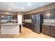 Stylish kitchen featuring stainless steel appliances, granite countertops, and ample dark wood cabinetry at 10404 Mystic Pine Rd, Las Vegas, NV 89135