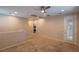 Open loft area with carpet, neutral walls, recessed lights, and door leading outside, perfect for relaxation and gatherings at 10404 Mystic Pine Rd, Las Vegas, NV 89135
