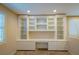 Loft desk with built-in cabinets and shelving, perfect for storage and organization, illuminated with recessed lighting at 10404 Mystic Pine Rd, Las Vegas, NV 89135