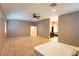 Spacious main bedroom featuring neutral walls, carpet, ceiling fan, and bathroom access at 10404 Mystic Pine Rd, Las Vegas, NV 89135