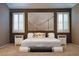 Beautiful main bedroom featuring soft carpet and a stunning decorative accent wall at 10404 Mystic Pine Rd, Las Vegas, NV 89135