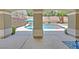 Backyard view of custom pool with mature landscaping and a backyard pergola at 10673 Bonchester Hill St, Las Vegas, NV 89141