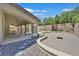 Backyard view of landscaped yard featuring covered patio and custom pool at 10673 Bonchester Hill St, Las Vegas, NV 89141