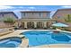 Inviting backyard features a sparkling pool and spa, perfect for relaxation and entertaining at 10673 Bonchester Hill St, Las Vegas, NV 89141