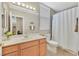 A bathroom with single vanity, tile flooring, and a shower and tub combo at 10673 Bonchester Hill St, Las Vegas, NV 89141