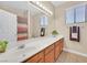 Bathroom with large mirror, double vanity, and shower at 10673 Bonchester Hill St, Las Vegas, NV 89141