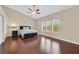 Spacious bedroom with wood floors, large windows, and a ceiling fan at 10673 Bonchester Hill St, Las Vegas, NV 89141