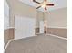 A secondary bedroom with neutral carpeting and paint and access to the bathroom at 10673 Bonchester Hill St, Las Vegas, NV 89141
