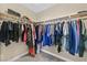 Walk-in closet with clothes hanging on rods at 10673 Bonchester Hill St, Las Vegas, NV 89141
