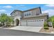Charming two-story home with a three-car garage and a well-maintained front yard at 10673 Bonchester Hill St, Las Vegas, NV 89141