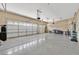 Large three car garage with finished epoxy floors and extra tall garage doors at 10673 Bonchester Hill St, Las Vegas, NV 89141