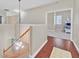 Hallway with wood floors, staircase and view of the primary bedroom with carpet at 10673 Bonchester Hill St, Las Vegas, NV 89141