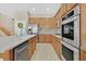 A modern kitchen featuring stainless steel appliances, light wood cabinetry, and a large island at 10673 Bonchester Hill St, Las Vegas, NV 89141