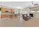 Spacious living room with an island, fireplace, and backyard view at 10673 Bonchester Hill St, Las Vegas, NV 89141