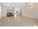 Expansive living room area with tile floors and an open staircase at 10673 Bonchester Hill St, Las Vegas, NV 89141
