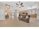 Open-concept living area with staircase, kitchen, and tile flooring at 10673 Bonchester Hill St, Las Vegas, NV 89141