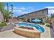 Backyard featuring a large inground pool, palm trees, and covered patio at 10673 Bonchester Hill St, Las Vegas, NV 89141