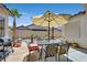 Backyard patio featuring flagstone, patio table set, desert landscaping, and outdoor grill at 10701 Morning Harbor Ave, Las Vegas, NV 89129