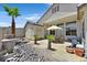 Paver patio and rock landscaping create a relaxing outdoor space in the backyard at 10701 Morning Harbor Ave, Las Vegas, NV 89129