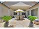 Enclosed backyard patio boasts stone flooring, shade, and a desert landscape at 10701 Morning Harbor Ave, Las Vegas, NV 89129