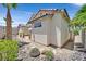 Desert landscape with rock features compliment backyard exterior of home with tile roof at 10701 Morning Harbor Ave, Las Vegas, NV 89129
