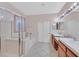 Bathroom with double sinks, large soaking tub, walk-in shower, and neutral color palette at 10701 Morning Harbor Ave, Las Vegas, NV 89129