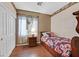 Bedroom features wood floors, closet, window, and bed at 10701 Morning Harbor Ave, Las Vegas, NV 89129