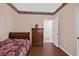 Bedroom featuring wood floors, closet, and bed at 10701 Morning Harbor Ave, Las Vegas, NV 89129