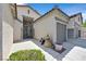 Home entrance features a gated courtyard, two-car garage, and upgraded landscaping at 10701 Morning Harbor Ave, Las Vegas, NV 89129