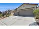 Three-car garage and spacious driveway of home enhance its curb appeal at 10701 Morning Harbor Ave, Las Vegas, NV 89129