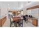 Bright eat-in kitchen features stainless appliances, wooden cabinets, and adjacent workspace at 10701 Morning Harbor Ave, Las Vegas, NV 89129