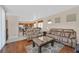 Open living area features wood floors, a large window, and comfortable furniture at 10701 Morning Harbor Ave, Las Vegas, NV 89129