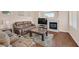 Comfortable living room features a fireplace, hardwood floors, and a sofa at 10701 Morning Harbor Ave, Las Vegas, NV 89129