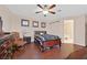 Well-lit main bedroom features a ceiling fan, hardwood floors, and an attached bathroom at 10701 Morning Harbor Ave, Las Vegas, NV 89129