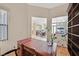 Cozy office setup with a classic desk and views to connected kitchen and living areas at 10701 Morning Harbor Ave, Las Vegas, NV 89129
