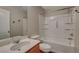 Bathroom featuring a tub and shower combination, clean white fixtures, and plenty of storage space at 10804 Mason Hill Ave, Las Vegas, NV 89166