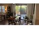 Dining table with chairs and plants in front of sliding glass doors to the backyard at 10804 Mason Hill Ave, Las Vegas, NV 89166